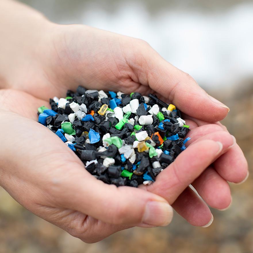 Colorful plastic pellets in a hand